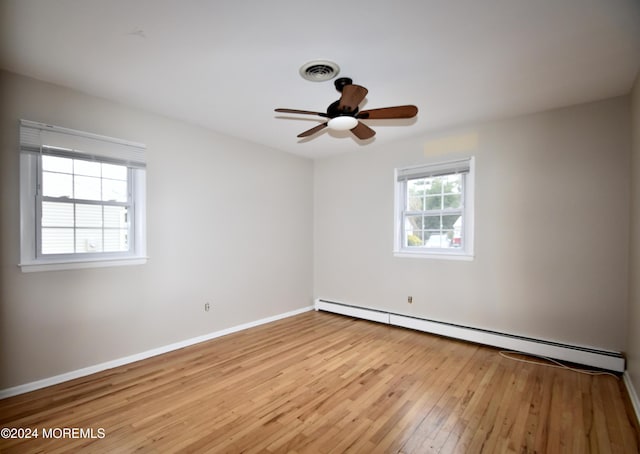 empty room with ceiling fan, light hardwood / wood-style flooring, and a baseboard radiator