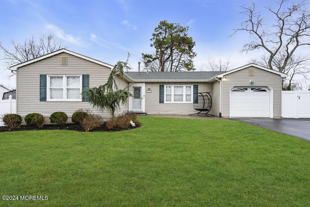 single story home with a front lawn and a garage