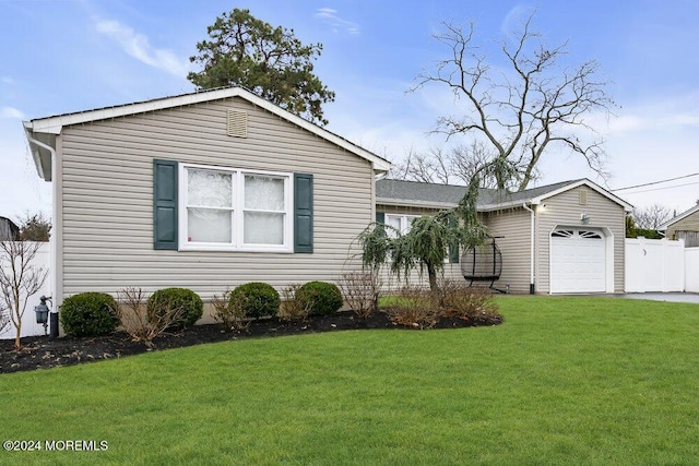 view of front of home with a front lawn and a garage