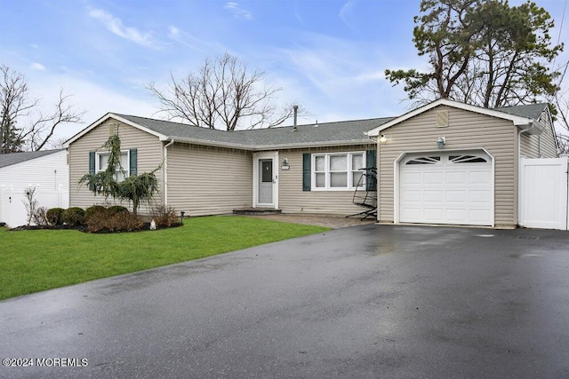 single story home with a front yard and a garage