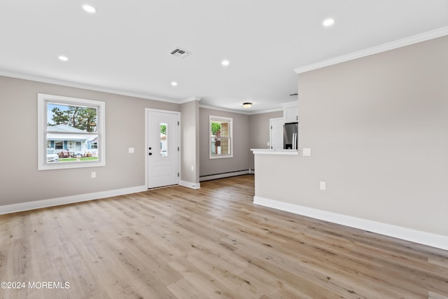 unfurnished living room featuring ornamental molding, a baseboard heating unit, and light wood-type flooring