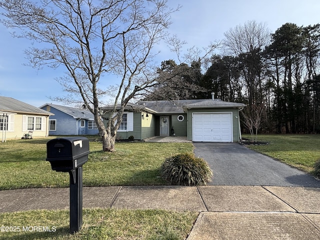 ranch-style house featuring a garage and a front yard