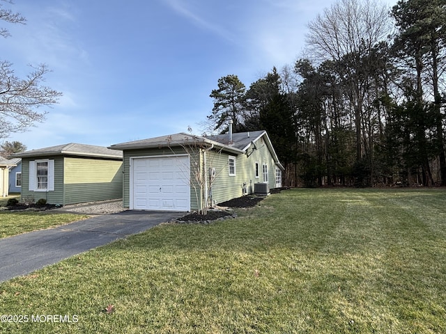 view of property exterior featuring central AC unit, a garage, and a lawn