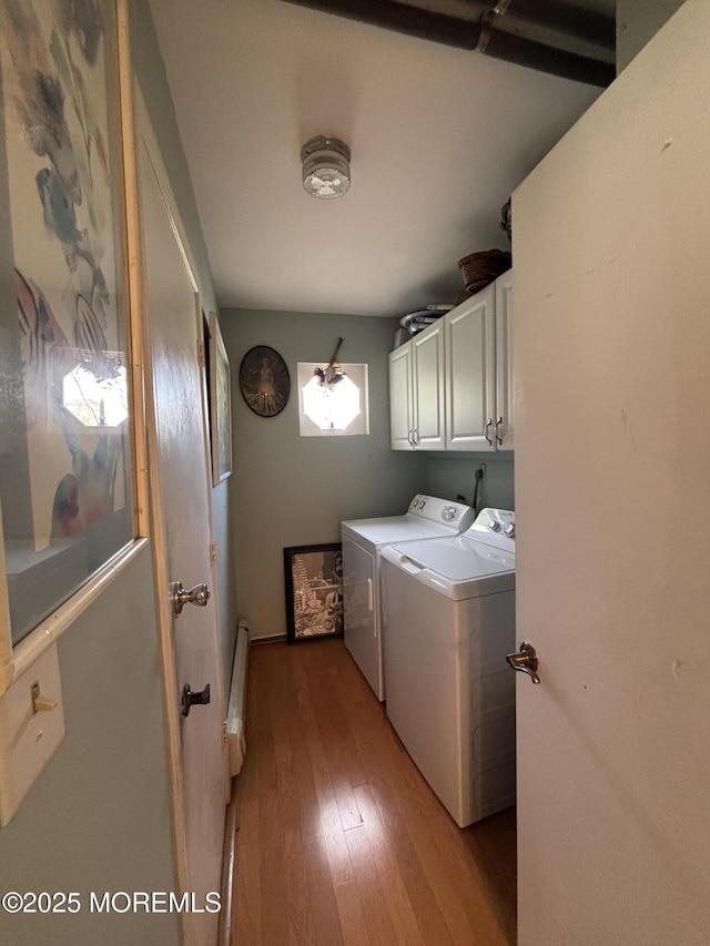 washroom with light hardwood / wood-style floors, cabinets, and independent washer and dryer