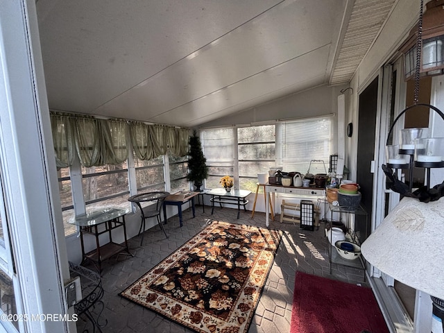 sunroom with plenty of natural light and lofted ceiling