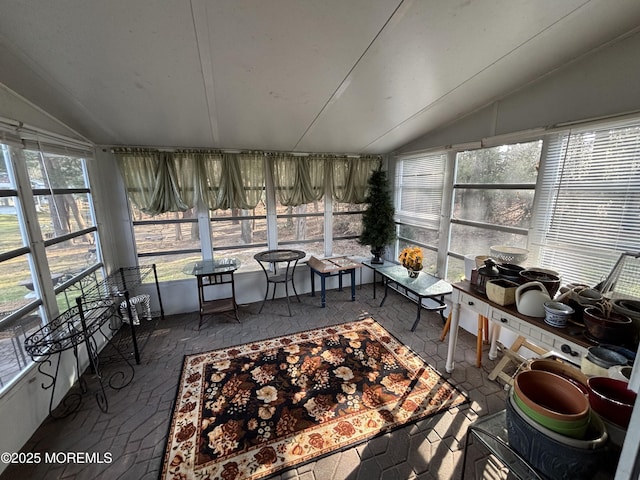 sunroom / solarium featuring lofted ceiling