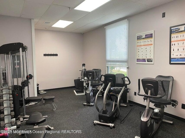 gym featuring a paneled ceiling and plenty of natural light