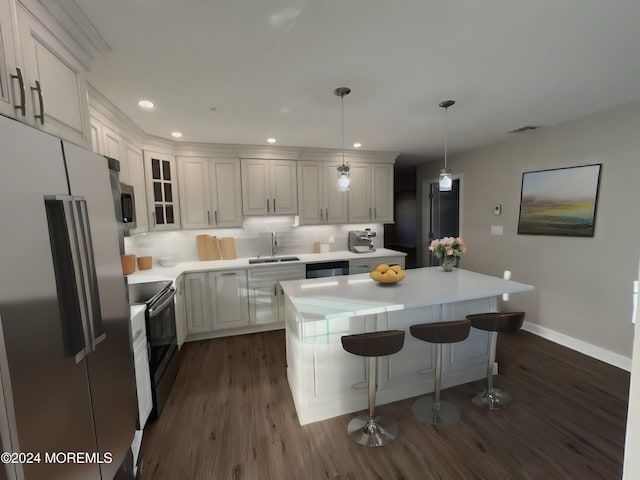 kitchen featuring white cabinets, stainless steel appliances, hanging light fixtures, and sink