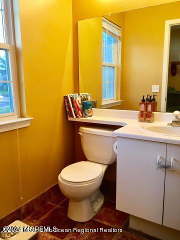 bathroom featuring tile patterned flooring, vanity, and toilet