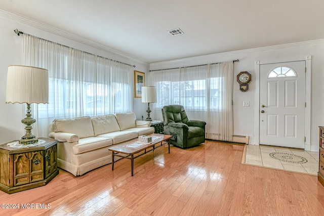 living room featuring plenty of natural light, ornamental molding, and light hardwood / wood-style flooring