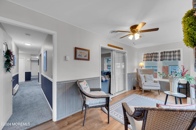 living area with ceiling fan and carpet floors