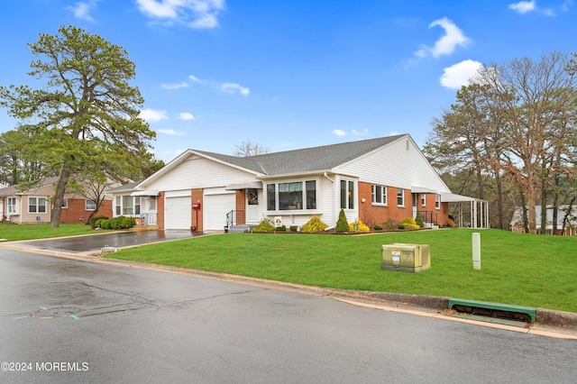 ranch-style house featuring a garage and a front lawn