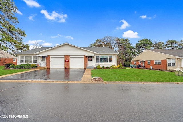 ranch-style home with a front yard and a garage