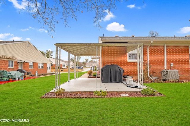 rear view of property featuring a lawn and a patio