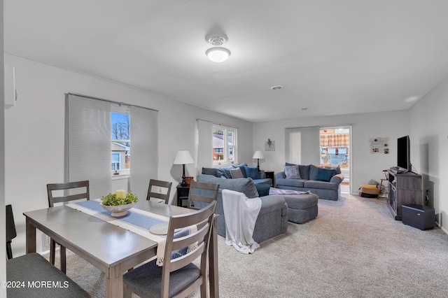 carpeted dining room featuring a healthy amount of sunlight