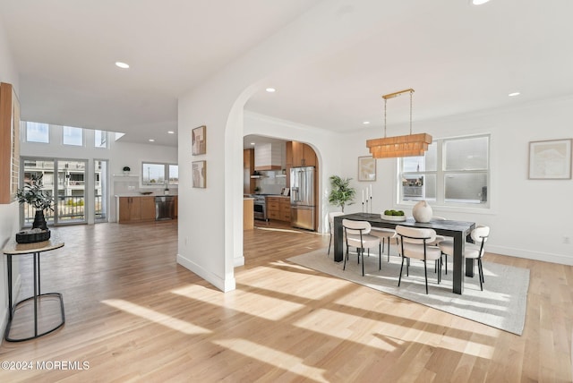 dining room featuring ornamental molding and light hardwood / wood-style flooring