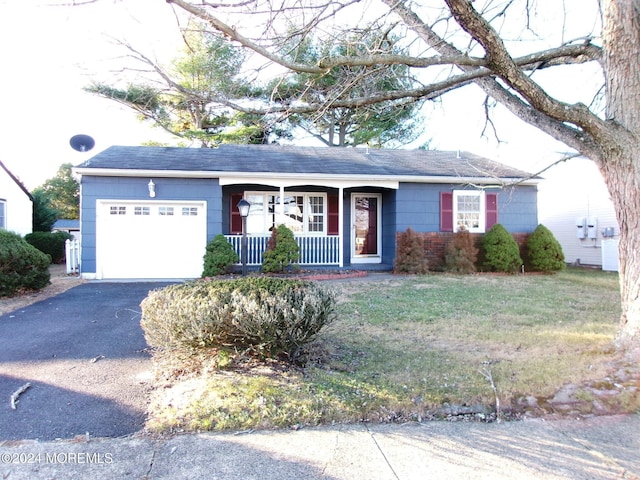 ranch-style house with covered porch, a garage, and a front lawn