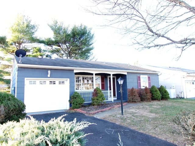 ranch-style home with a porch and a garage