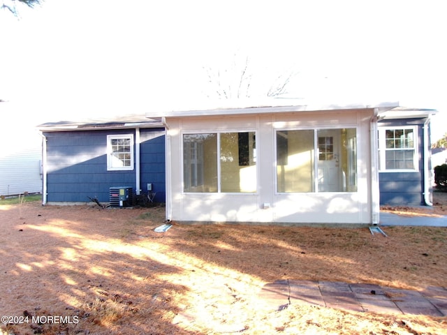 back of house with central AC and a sunroom