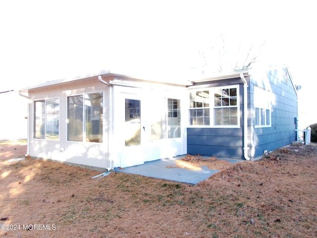 back of property featuring a sunroom