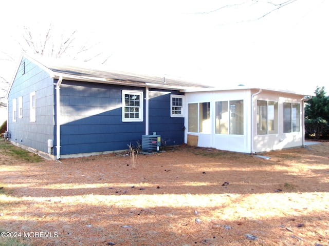 back of property with a sunroom and cooling unit