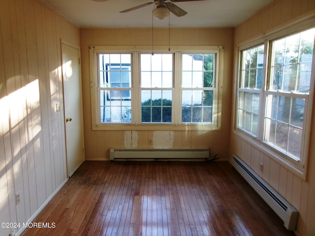 unfurnished sunroom with plenty of natural light, ceiling fan, and a baseboard radiator