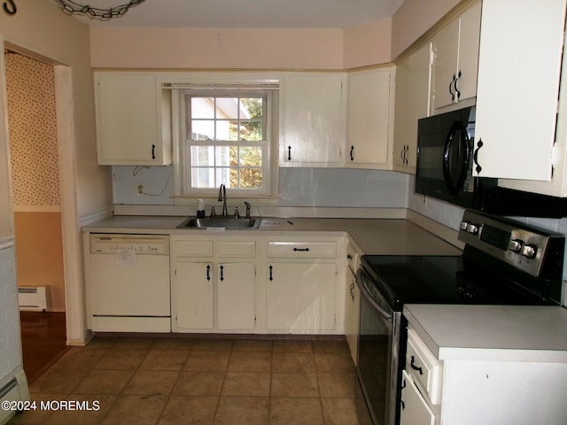 kitchen featuring tile patterned floors, baseboard heating, sink, black appliances, and white cabinetry