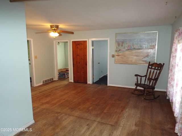 unfurnished room featuring ceiling fan and dark hardwood / wood-style floors