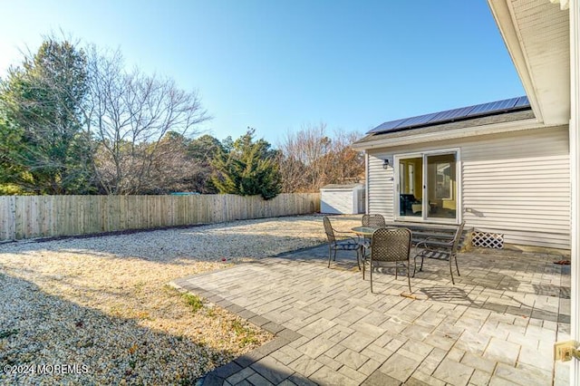 view of patio / terrace with a shed