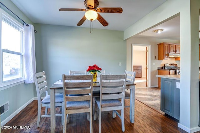 dining space featuring ceiling fan and dark hardwood / wood-style flooring