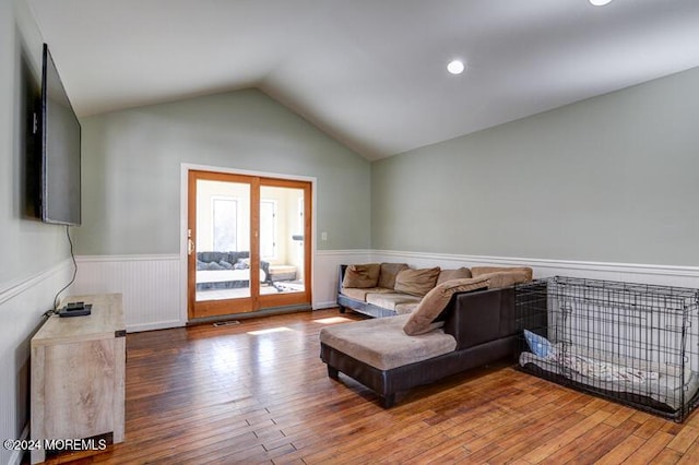 living room featuring wood-type flooring and lofted ceiling