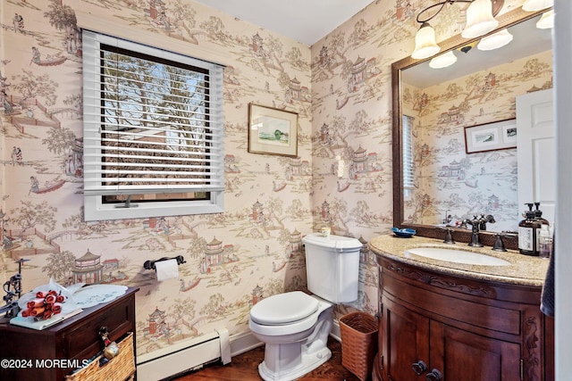 bathroom with vanity, toilet, and a baseboard radiator