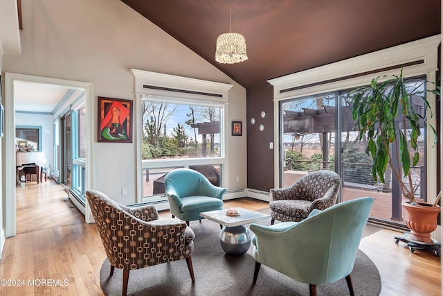 sitting room with light hardwood / wood-style flooring, high vaulted ceiling, and a notable chandelier