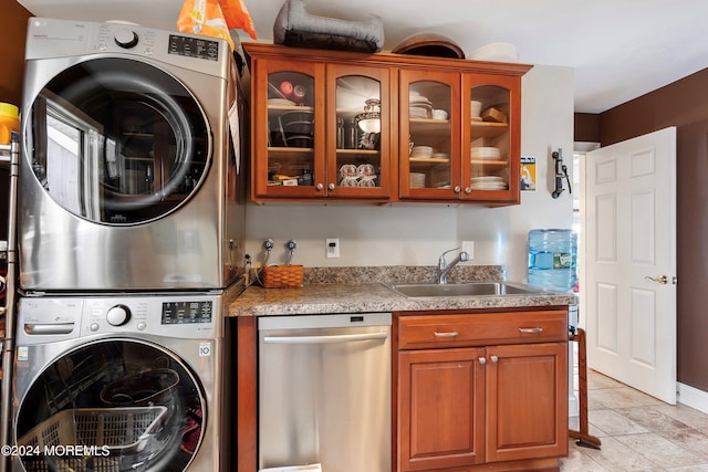 laundry area featuring sink and stacked washer and clothes dryer