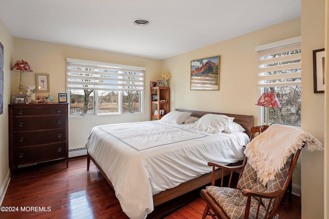 bedroom featuring dark hardwood / wood-style floors and a baseboard radiator