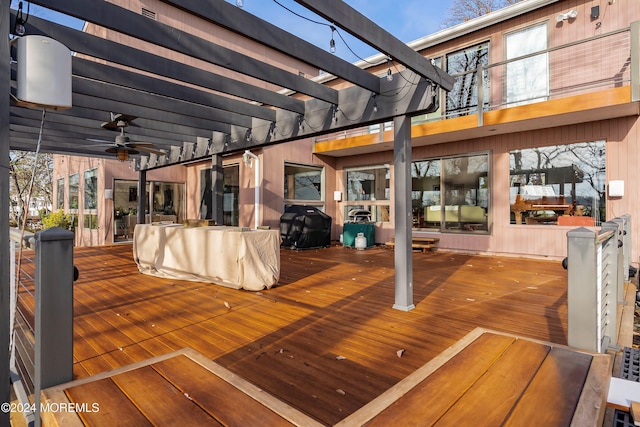 deck featuring a pergola, a grill, and ceiling fan