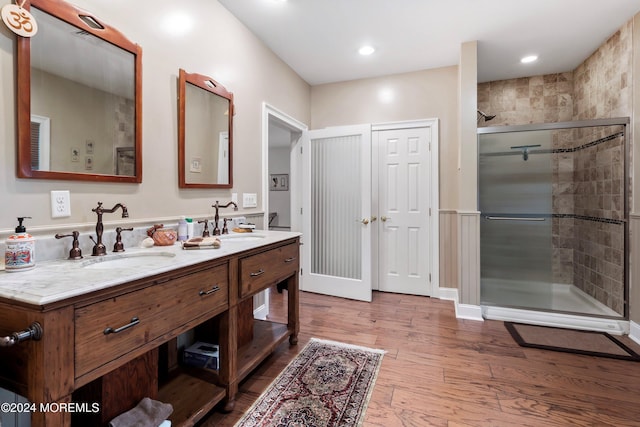 bathroom featuring hardwood / wood-style floors, vanity, and walk in shower