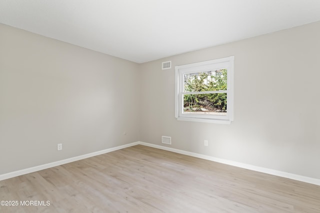 empty room with light hardwood / wood-style floors