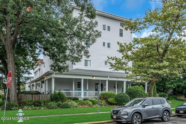 view of front of house featuring a front yard and a porch