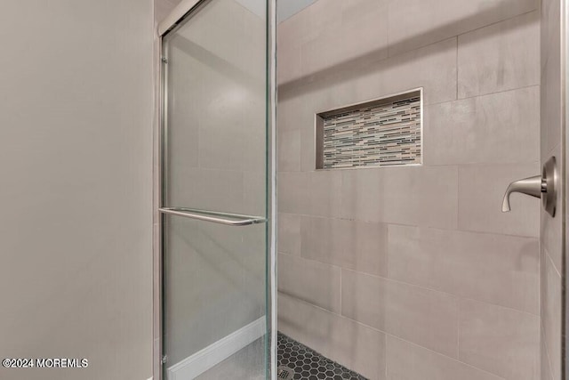 bathroom with a shower with shower door