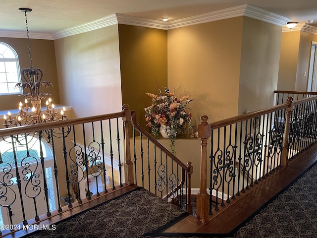 staircase featuring crown molding and a notable chandelier