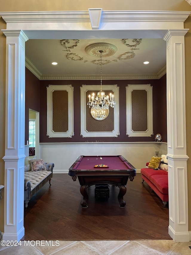 game room with ornamental molding, decorative columns, a notable chandelier, and billiards