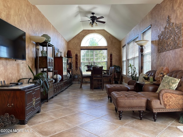 living room with light tile patterned floors, high vaulted ceiling, and ceiling fan