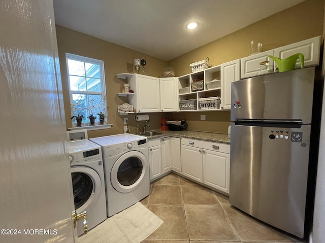 laundry area with separate washer and dryer, sink, and light tile patterned floors