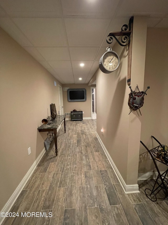 hallway with a paneled ceiling