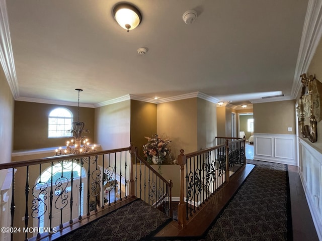 hallway with a chandelier and ornamental molding