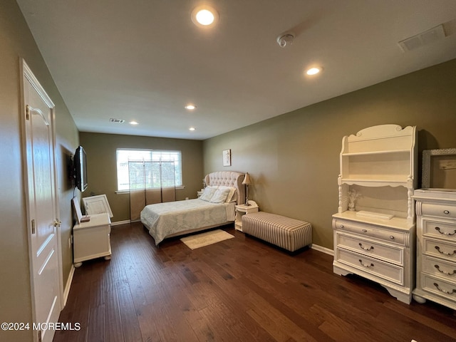 bedroom with dark wood-type flooring