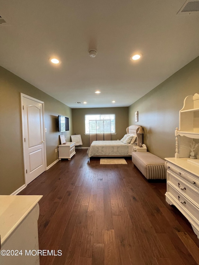 bedroom with dark hardwood / wood-style floors