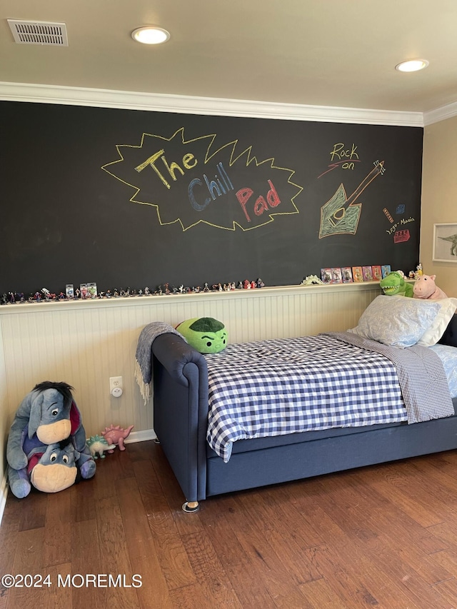 bedroom featuring hardwood / wood-style flooring and crown molding