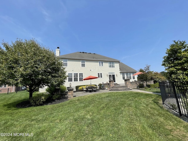 back of house featuring a patio area and a yard